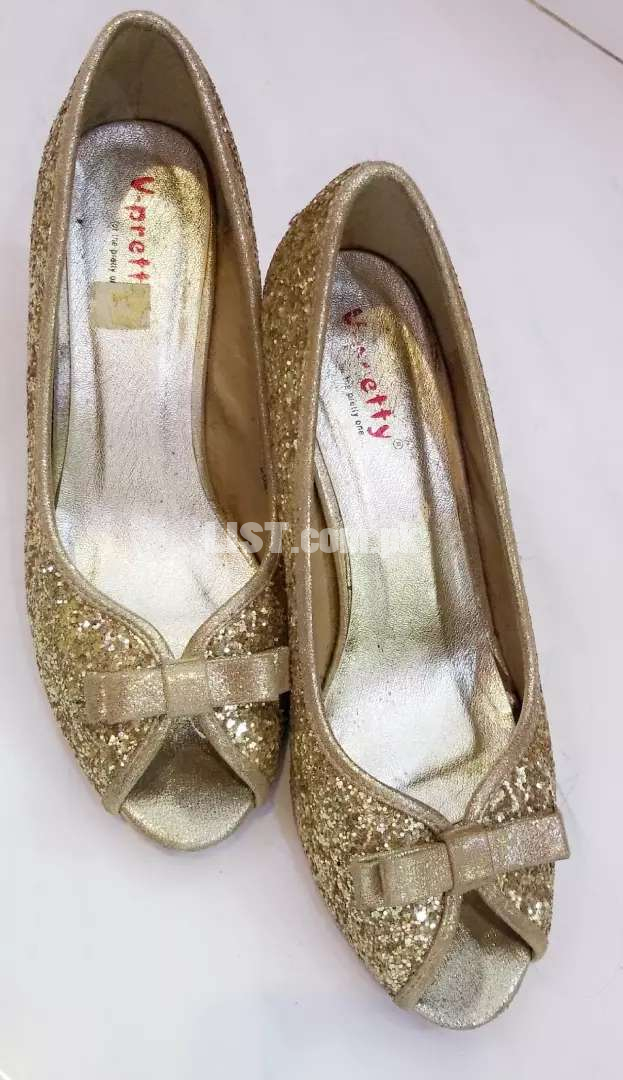 Golden pumps by Brand city, used multiple times