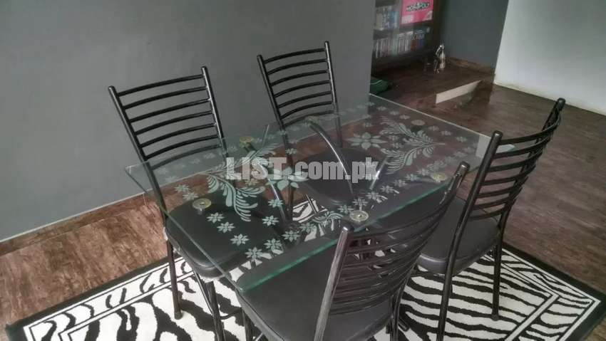 Four person steel and glass dining table with chairs