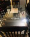 Dining table of 6 chairs with wooden desgine base glass top 12 mm