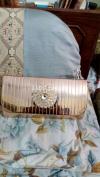 A beautiful golden clutch for sale.