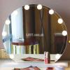 Mirror with light bulbs and cosmetic products.